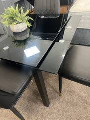 Glass extendable dining table with four chairs