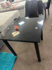 Glass extendable dining table with four chairs