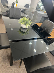 Glass extendable dining table with four chairs
