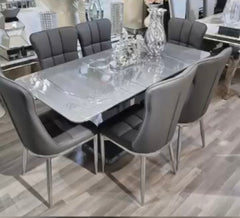 Extendable dining table with six chairs offering flexibility and stylish functionality.