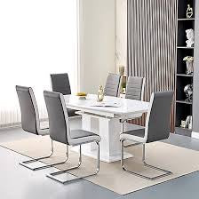 Marble dining table with six chairs featuring elegant design and comfortable seating.