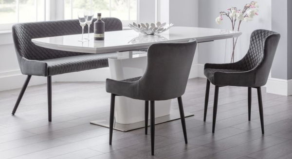 Sintered stone extendable dining table with six chairs for modern dining spaces.