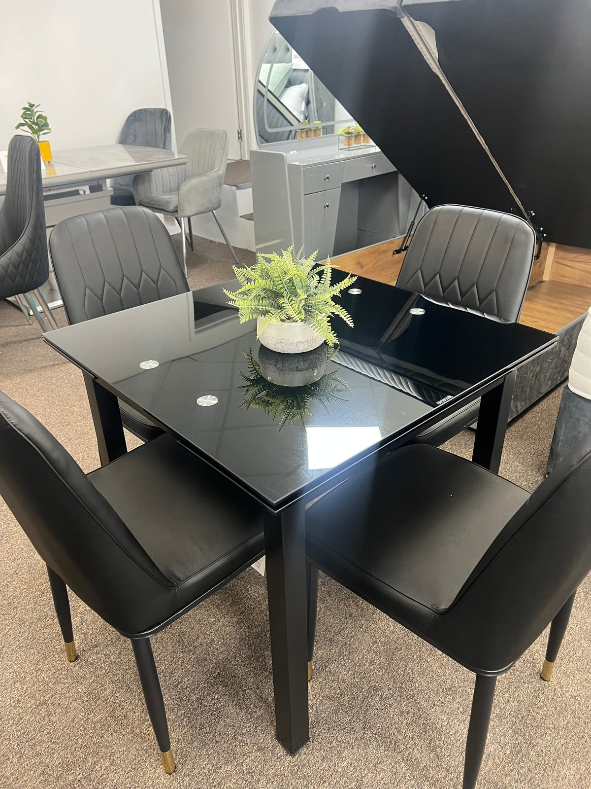 Glass extendable dining table with four chairs