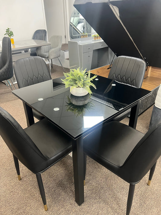 Glass extendable dining table with four chairs