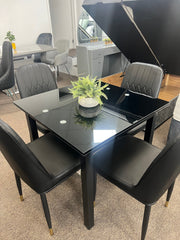 Glass extendable dining table with four chairs
