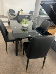 Glass extendable dining table with four chairs