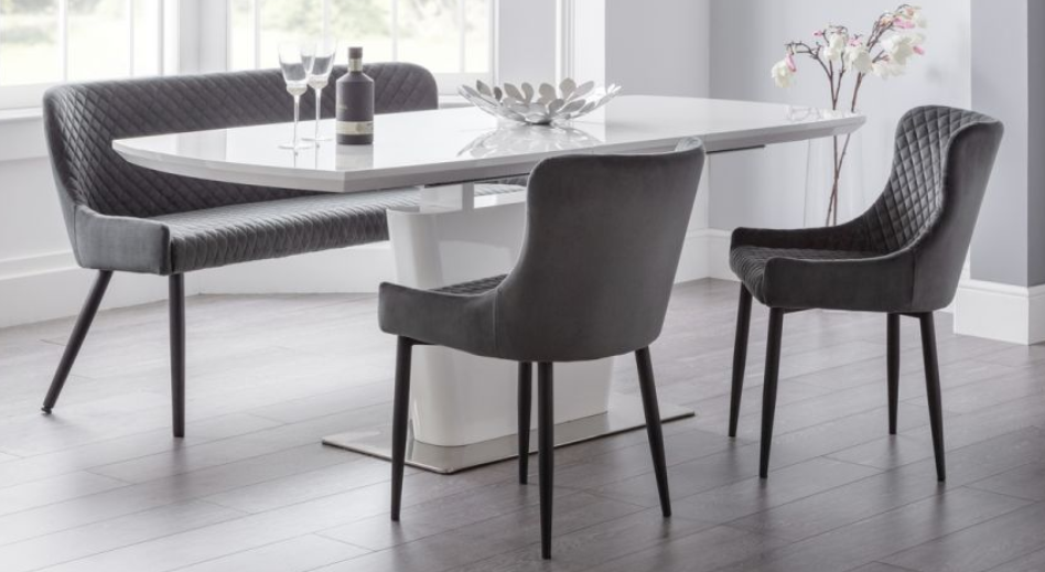 Sintered stone extendable dining table with six chairs for modern dining spaces.