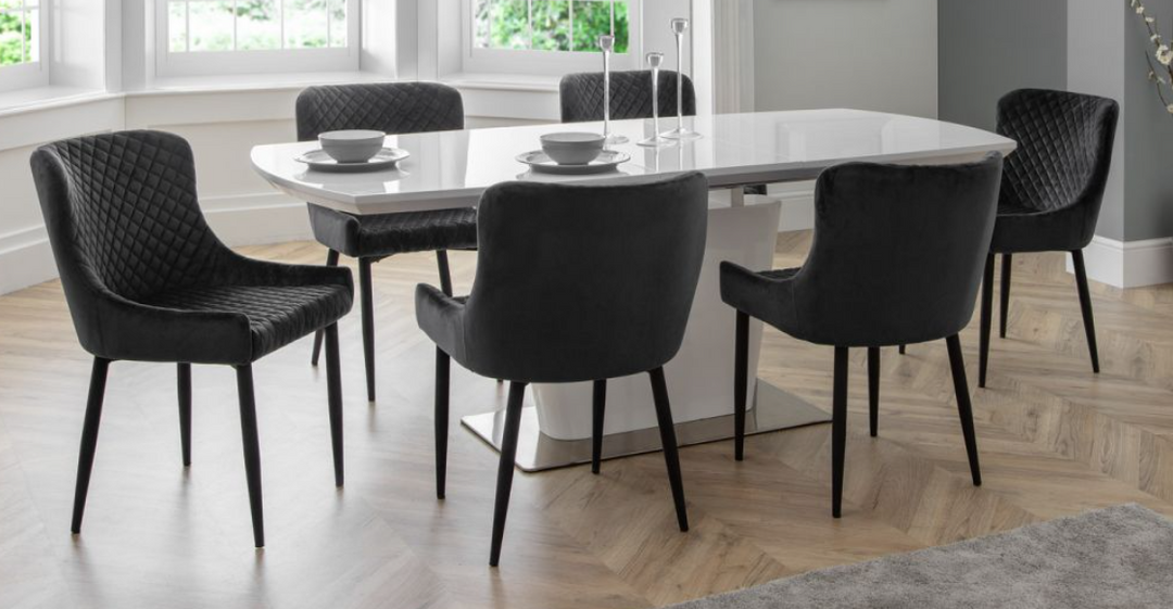 Sintered stone extendable dining table with six chairs for modern dining spaces.